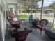 Screened porch with wicker furniture and view of street at 185 Jacaranda Dr, Leesburg, FL 34748