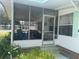 Relaxing screened porch with wicker furniture at 185 Jacaranda Dr, Leesburg, FL 34748