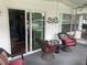 Relaxing screened porch with wicker chairs and view of the backyard at 185 Jacaranda Dr, Leesburg, FL 34748