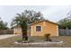 Orange house with palm trees and landscaping at 1906 Nancy Ann Ter, Ocoee, FL 34761