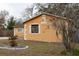 Side view of orange house with mature trees at 1906 Nancy Ann Ter, Ocoee, FL 34761