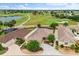 Lovely aerial view of a home located on a golf course, surrounded by lush landscaping and mature trees at 1941 Loadstar Ave, The Villages, FL 32162