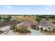 Beautiful home overlooks a golf course with lush landscaping and a long driveway in a sunny neighborhood at 1941 Loadstar Ave, The Villages, FL 32162