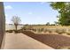 Scenic backyard with a white picket fence, lush landscaping, and views of the golf course at 1941 Loadstar Ave, The Villages, FL 32162