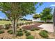 Landscaped backyard with a view of the golf course beyond a white picket fence and manicured garden at 1941 Loadstar Ave, The Villages, FL 32162