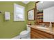 Cozy bathroom features a granite vanity, updated sink, a framed mirror, and a decorative giraffe theme at 1941 Loadstar Ave, The Villages, FL 32162