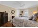 Comfortable bedroom with two twin beds, ceiling fan, and wood floors creating a cozy and inviting atmosphere at 1941 Loadstar Ave, The Villages, FL 32162