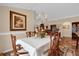 This dining room features a chandelier, hardwood floors, and decorative painting, creating an inviting atmosphere at 1941 Loadstar Ave, The Villages, FL 32162