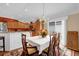 Bright dining room with chandelier, adjacent kitchen, and sliding glass doors leading to the outdoor area at 1941 Loadstar Ave, The Villages, FL 32162