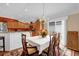 Bright dining room with a charming chandelier and wood dining set at 1941 Loadstar Ave, The Villages, FL 32162