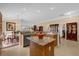 Well-equipped kitchen with stone countertops, stainless steel appliances, and center island overlooking the living area at 1941 Loadstar Ave, The Villages, FL 32162