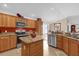 Modern eat-in kitchen with stainless appliances, center island, and light wood cabinets at 1941 Loadstar Ave, The Villages, FL 32162