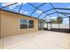 A view of the screened lanai with a concrete floor, showing the connection to the home's exterior at 1941 Loadstar Ave, The Villages, FL 32162