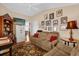 Cozy living room with comfortable seating, decorative shelving, and TV, perfect for relaxation and entertainment at 1941 Loadstar Ave, The Villages, FL 32162