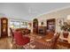 Cozy living room with hardwood floors, fireplace, and comfortable seating arrangement with plenty of natural light at 1941 Loadstar Ave, The Villages, FL 32162