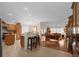 Bright open-concept living room with hardwood floors, ample seating, and views of the kitchen and dining area at 1941 Loadstar Ave, The Villages, FL 32162