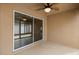 Covered porch area featuring tile flooring and sliding glass door access to the interior at 1941 Loadstar Ave, The Villages, FL 32162