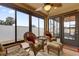 Relaxing sunroom with wicker furniture and screened enclosure at 1941 Loadstar Ave, The Villages, FL 32162