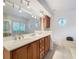 Bathroom with double vanity, large mirror, and octagon window at 2042 Eagles Rest Dr, Apopka, FL 32712