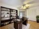 Home office with built-in shelving and hardwood floors at 2042 Eagles Rest Dr, Apopka, FL 32712