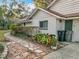 Landscaped side yard with stone pathway leading to the house at 2042 Eagles Rest Dr, Apopka, FL 32712