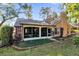 Charming house exterior with screened porch and manicured lawn at 2043 Sawgrass Dr, Apopka, FL 32712