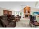 Living room with vaulted ceiling, fireplace, and brown leather sectional at 2043 Sawgrass Dr, Apopka, FL 32712