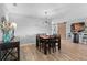 Dining room features a wood table, six chairs, and stylish light fixture at 2064 Lula Rd, Minneola, FL 34715