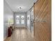 Inviting entryway featuring tile floors and a rustic barn door at 2064 Lula Rd, Minneola, FL 34715