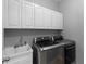 Laundry room with white cabinets, LG washer and dryer at 2064 Lula Rd, Minneola, FL 34715