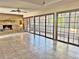 Bright Gathering room featuring tile floors, a brick fireplace, and sliding glass doors at 208 First St, Tavares, FL 32778