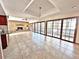 Bright Gathering room featuring tile floors, a brick fireplace, and sliding glass doors at 208 First St, Tavares, FL 32778