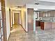 A long hallway with tile floors and access to other rooms at 208 First St, Tavares, FL 32778