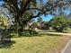 House exterior with lush landscaping and driveway at 208 First St, Tavares, FL 32778