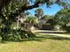 House exterior showcasing lush landscaping at 208 First St, Tavares, FL 32778