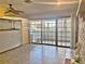 Bright living room with tile floors, fireplace, and sliding glass doors leading to patio at 208 First St, Tavares, FL 32778