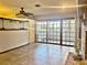 Bright living room with tile floors, fireplace, and sliding glass doors leading to patio at 208 First St, Tavares, FL 32778