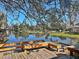 Wooden deck overlooking a tranquil lake with benches at 208 First St, Tavares, FL 32778