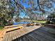 Wooden deck with benches overlooking a calm lake at 208 First St, Tavares, FL 32778