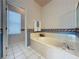 Bathroom featuring a bathtub, shower, and updated tile at 2289 Twickingham Ct, Clermont, FL 34711