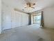 Bedroom with carpet flooring and access to a screened patio at 2289 Twickingham Ct, Clermont, FL 34711