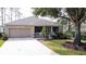 Single-story home with attached garage and landscaped yard at 2289 Twickingham Ct, Clermont, FL 34711