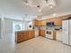 Kitchen with light wood cabinets, island and white appliances at 2289 Twickingham Ct, Clermont, FL 34711