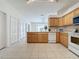 Kitchen with light wood cabinets and view of breakfast nook at 2289 Twickingham Ct, Clermont, FL 34711