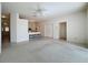 Spacious living room with carpet flooring and a view of the kitchen at 2289 Twickingham Ct, Clermont, FL 34711