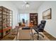 Home office with built-in shelving and hardwood floors at 2289 Twickingham Ct, Clermont, FL 34711