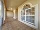 Screened porch with tiled flooring and arched window at 2289 Twickingham Ct, Clermont, FL 34711