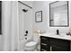 Clean bathroom with black vanity, white quartz countertop and a large mirror at 2320 Blue Meadows Ct, Apopka, FL 32703