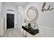 Bright entryway with a black door, console table, and large round mirror at 2320 Blue Meadows Ct, Apopka, FL 32703