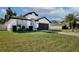 Modern, single-story home with a dark gray garage door and lush lawn at 2320 Blue Meadows Ct, Apopka, FL 32703